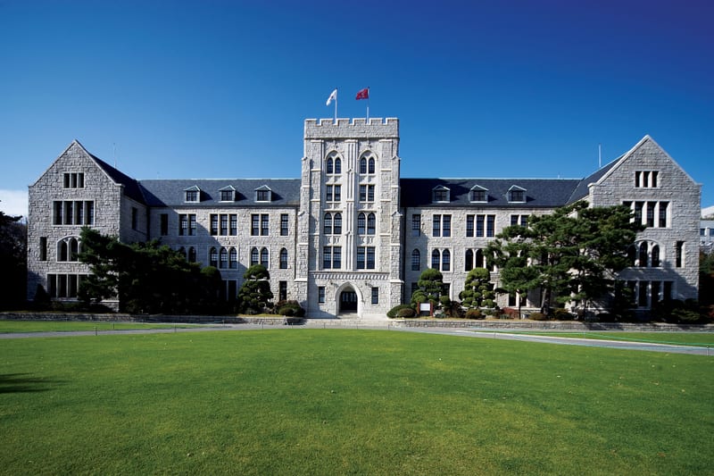 The stone facade of Korea University's Main Hall viewed across the front lawn.