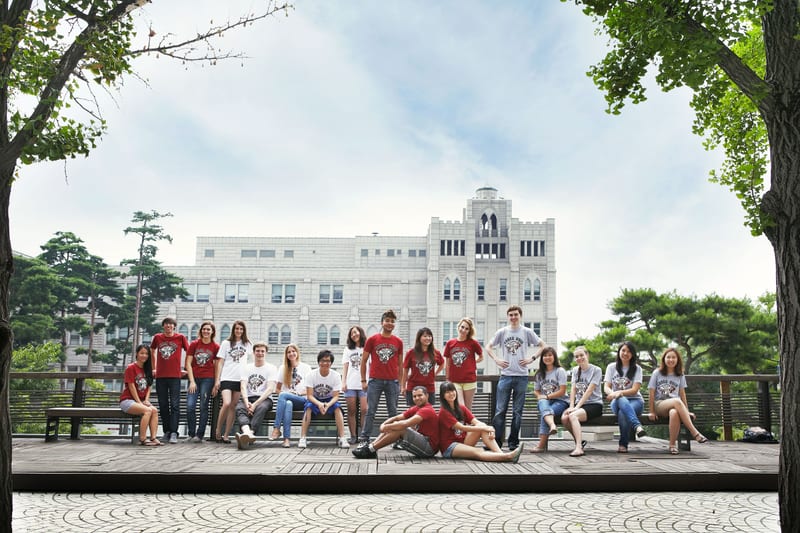 International students of Korea University gathered in front of the Main Hall, wearing KOREA UNIV. tees.
