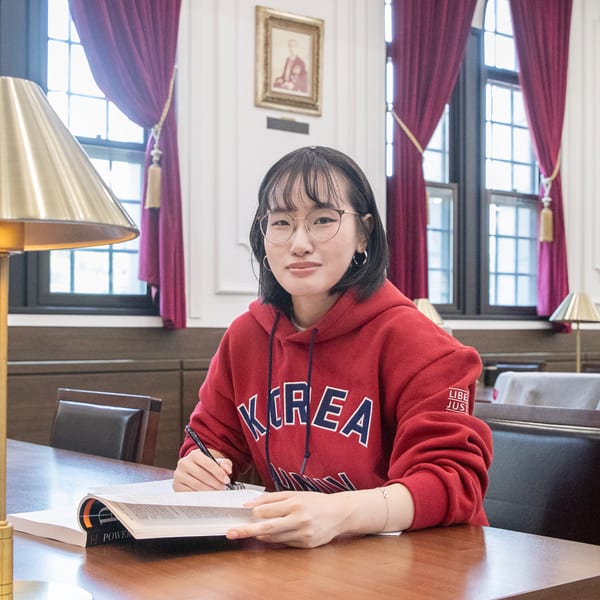 Pham Duong Cam Ly, an international student from Vietnam, studies English vocabulary at her desk in the library.
